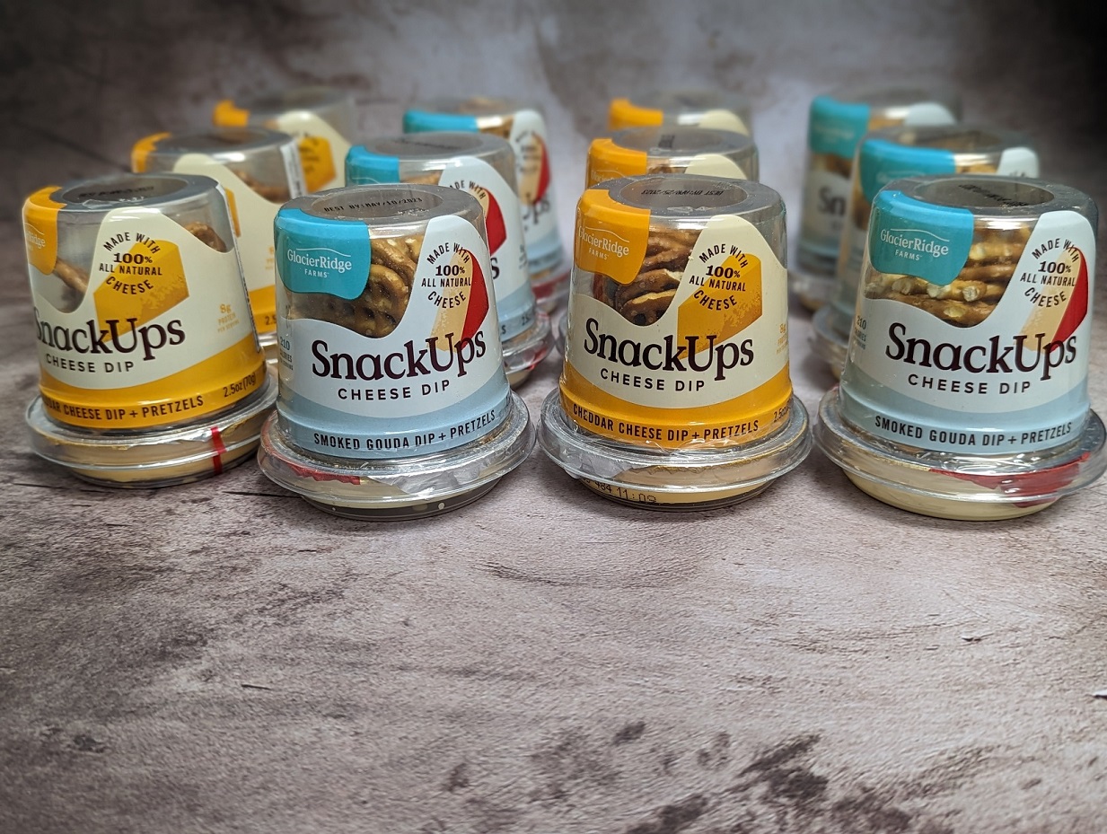 Grab and Go Snack Packs with cheese dip and pretzels ready to stock on shelves in many grocery stores, convenience stores, and online retailers. 